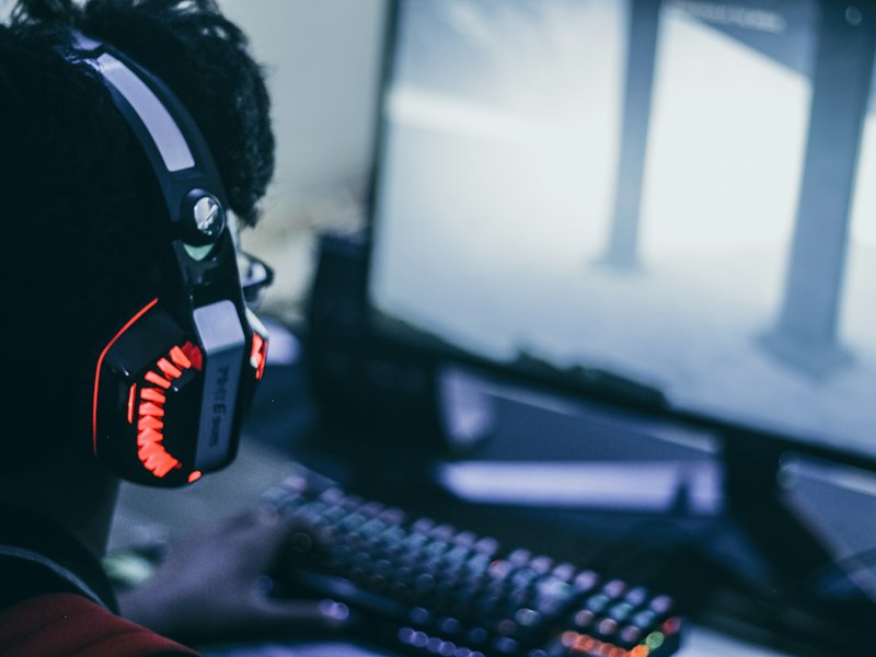 Editor writing a game review by monitor light